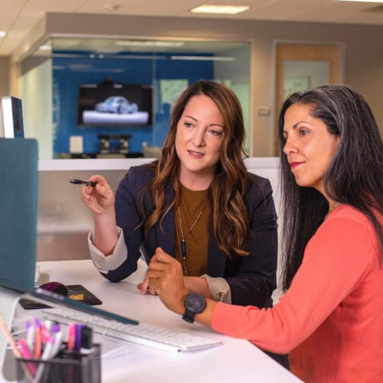 Team discussion around a laptop